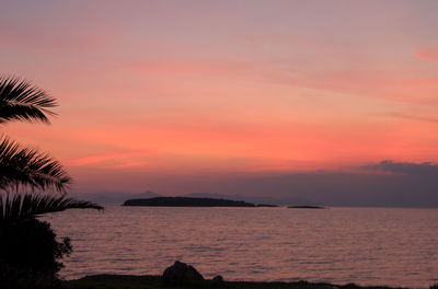 Scenic view of sea against romantic sky at sunset