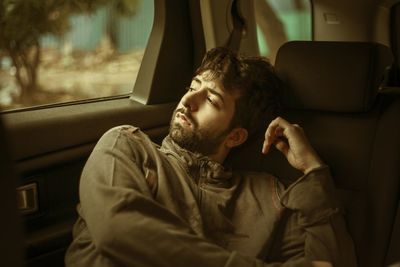 Midsection of man sitting in car