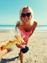 Friends toasting drinks at beach