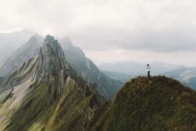 Scenic view of mountains against cloudy sky