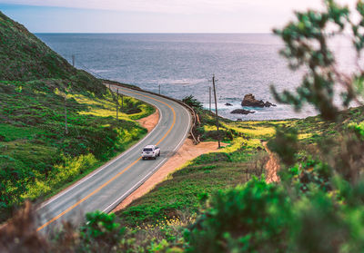 High angle view of road by sea against sky