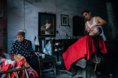 Young man with woman sitting in traditional clothing