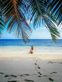 Woman from behind on sandy beach. one person, tropical, sea, beach.