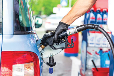 Filling petrol or diesel fuel in car at gas station