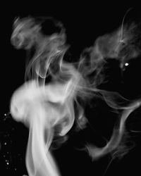 Close-up of smoke against black background