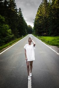 Portrait of woman walking on road