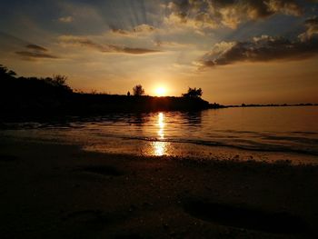 Scenic view of beach against sky during sunset