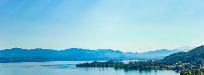 Scenic view of bay against clear blue sky