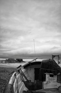 Boats moored on beach against sky