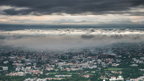 Aerial view of cityscape against cloudscape