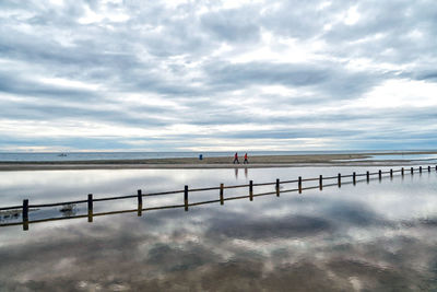 Pier over sea against sky