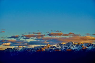 Scenic view of snowcapped mountains against sky during sunset