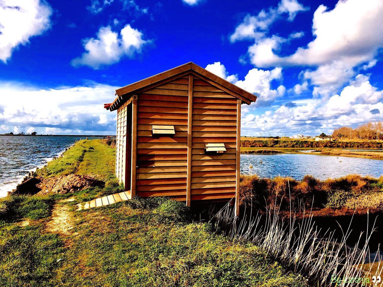 HUT ON BEACH AGAINST SKY