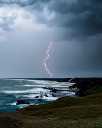 Lightning over sea against sky