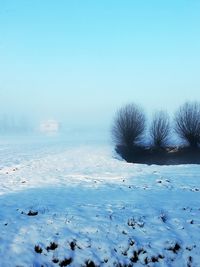 Scenic view of snow covered field against clear sky