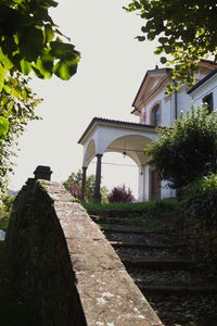 Footpath amidst buildings against clear sky