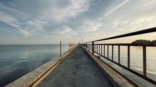 Pier over sea against sky