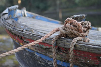 Close-up of rope tied to boat moored at harbor