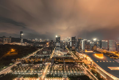 High angle view of illuminated cityscape against sky at night