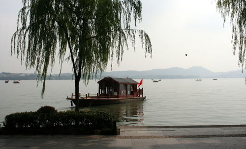 Scenic view of lake by building against sky