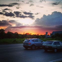 Car on road at sunset