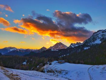 Scenic view of snowcapped mountains against sky during sunset