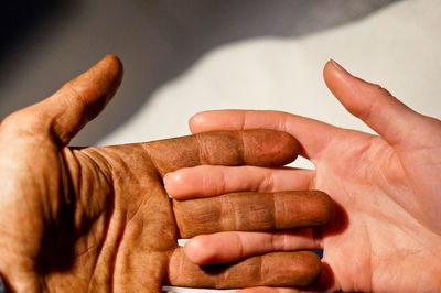 Cropped image of worker hand touching wife hand
