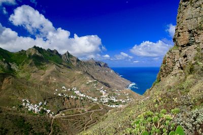 Panoramic shot of calm sea against mountain range