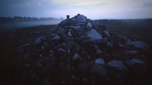 Rocks on beach against sky