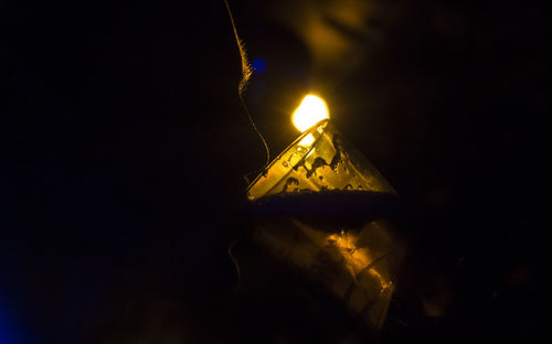 Close-up of illuminated lights over black background