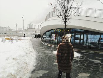 Rear view of people on street during winter