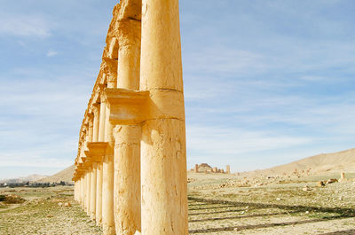 Low angle view of old ruin building against cloudy sky