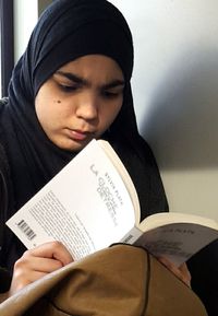 Close-up of woman reading book