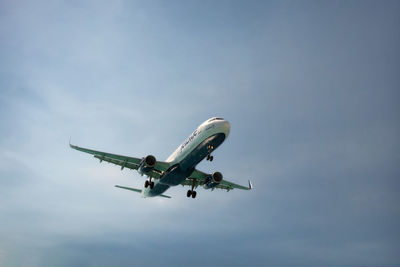 Low angle view of airplane flying in sky