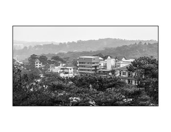 Houses and trees against sky