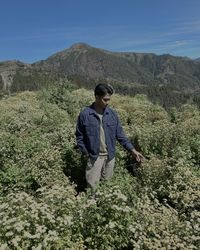 Rear view of man standing on mountain