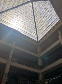 Low angle view of skylight in building against sky
