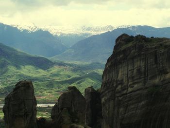 Scenic view of mountains against cloudy sky