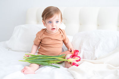 Portrait of cute baby boy sleeping on bed at home