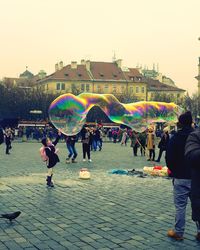 Panoramic view of rainbow over town square