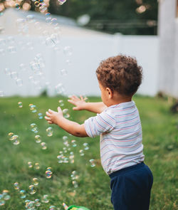 Side view of boy blowing bubbles