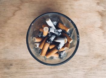 Close-up of cigarette smoking on table