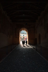 Rear view of people walking in building