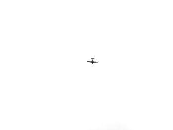 Low angle view of silhouette airplane against clear sky