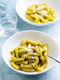 Plate of pasta with pesto genovese, with fresh basil, olive oil, garlic and pine nuts