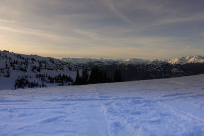 Snow covered field against sky