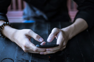 Midsection of man using phone