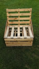 High angle view of empty bench in field