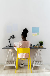 Young businesswoman working while sitting at home office