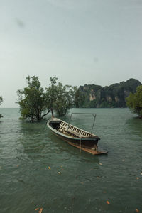 Boat floating on sea against sky